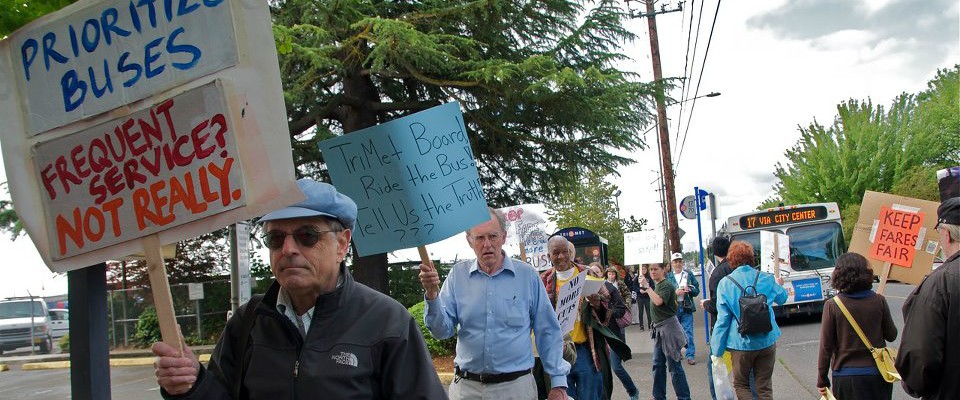 People protesting at a bus stop