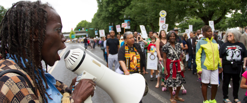Jo Ann Hardesty encourages a crowd with a bullhorn