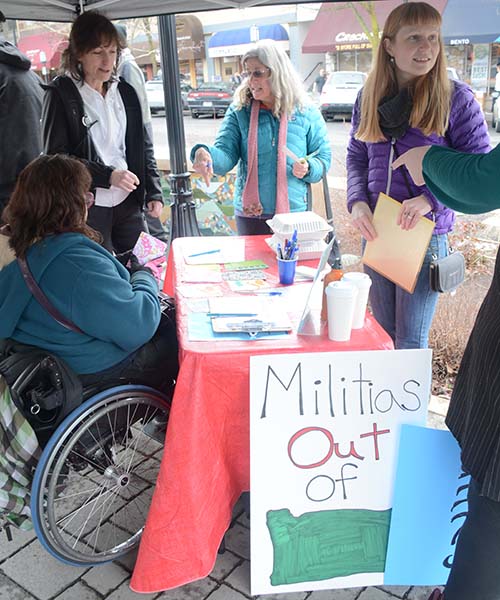 Oregon Action Executive Director Michelle Glass prepares for a rally with CBI cohort members as a part of their first convening in Ashland.