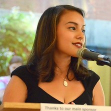 Andrea Valderrama speaks at a podium.